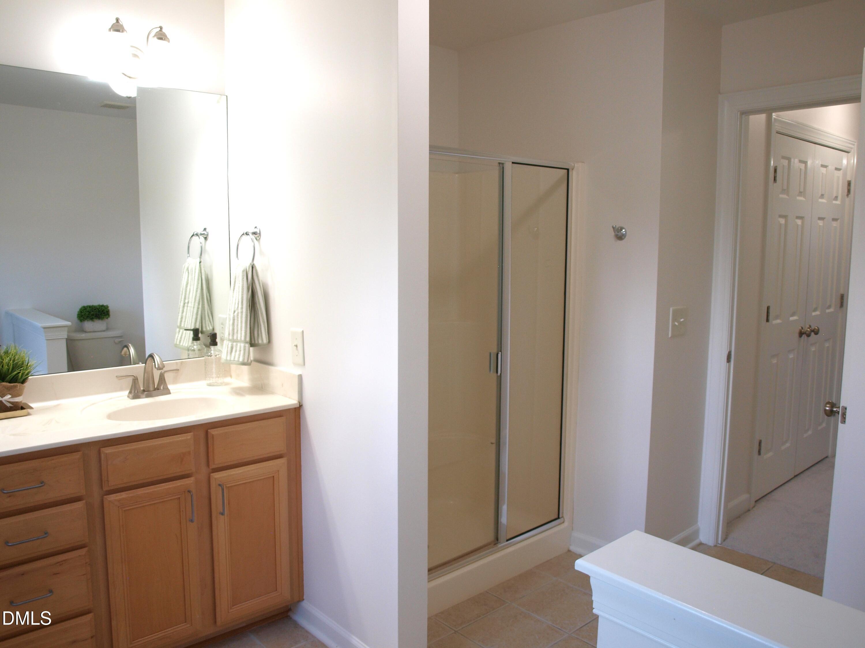 4815 Landover Charge Lane Raleigh, NC 27616 - Photo 11 of 18 a bathroom with a sink and a mirror