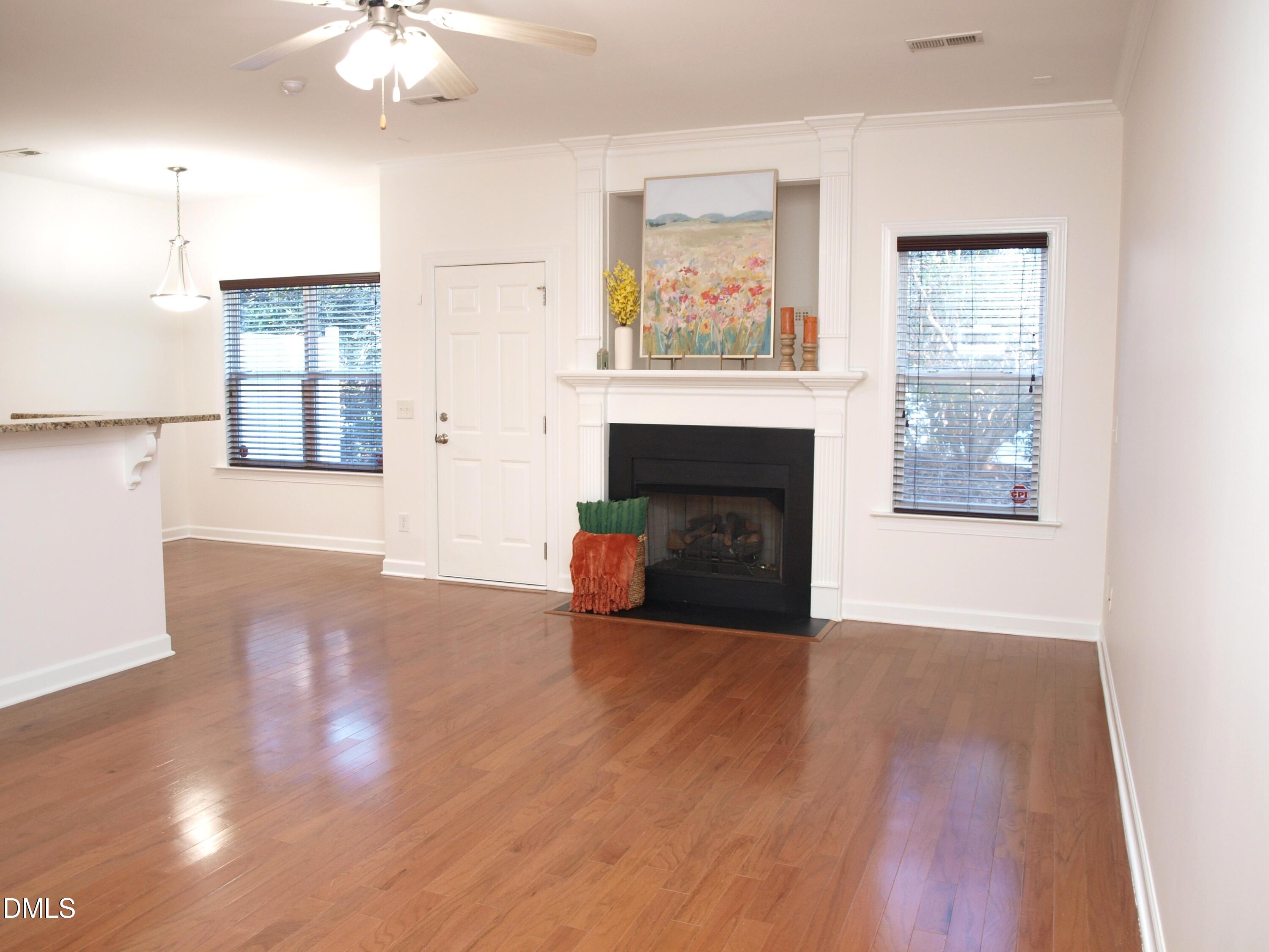4815 Landover Charge Lane Raleigh, NC 27616 - Photo 2 of 18 a view of an empty room with wooden floor and a window
