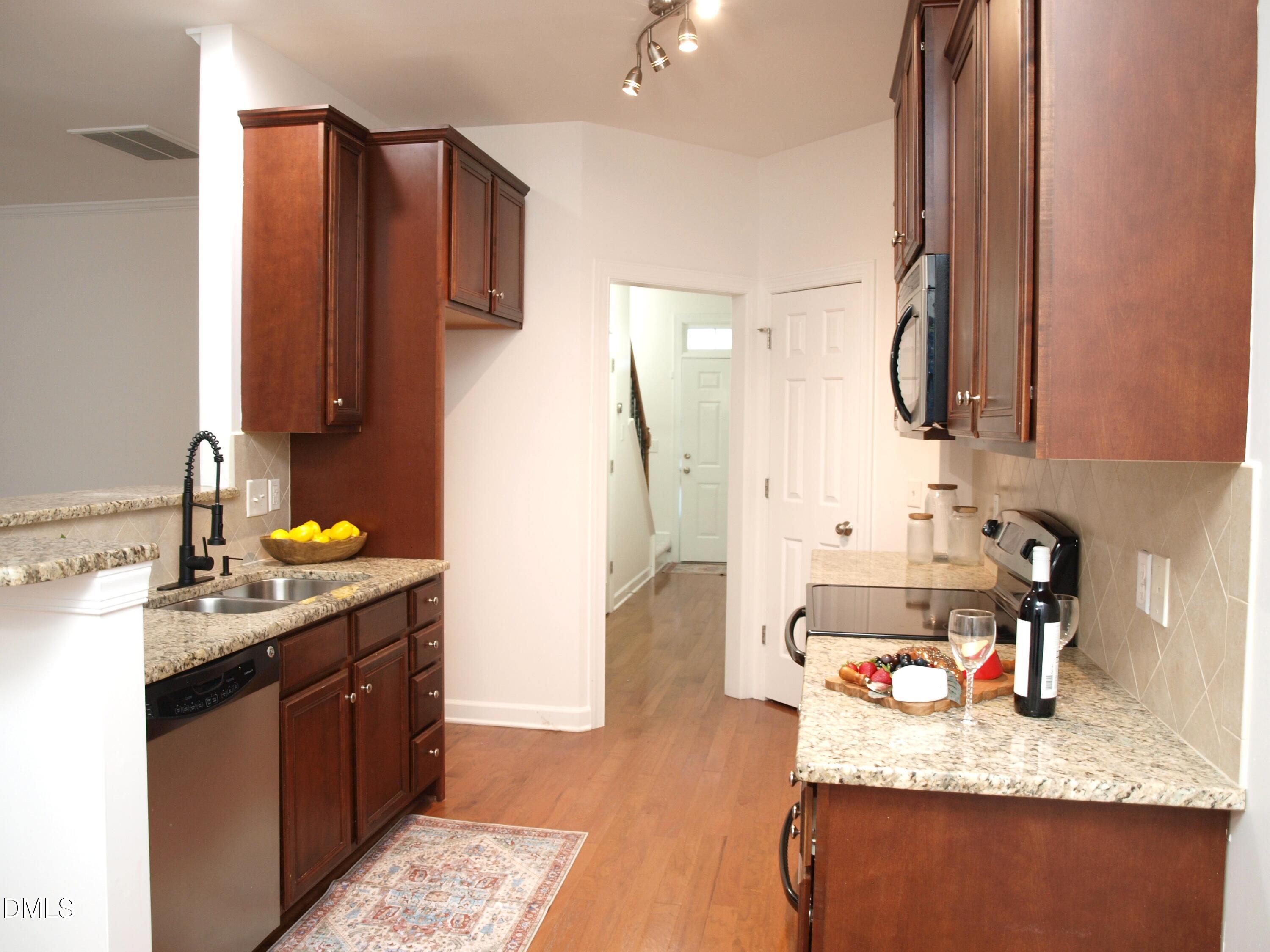 4815 Landover Charge Lane Raleigh, NC 27616 - Photo 5 of 18 a bathroom with a granite countertop sink a toilet and mirror