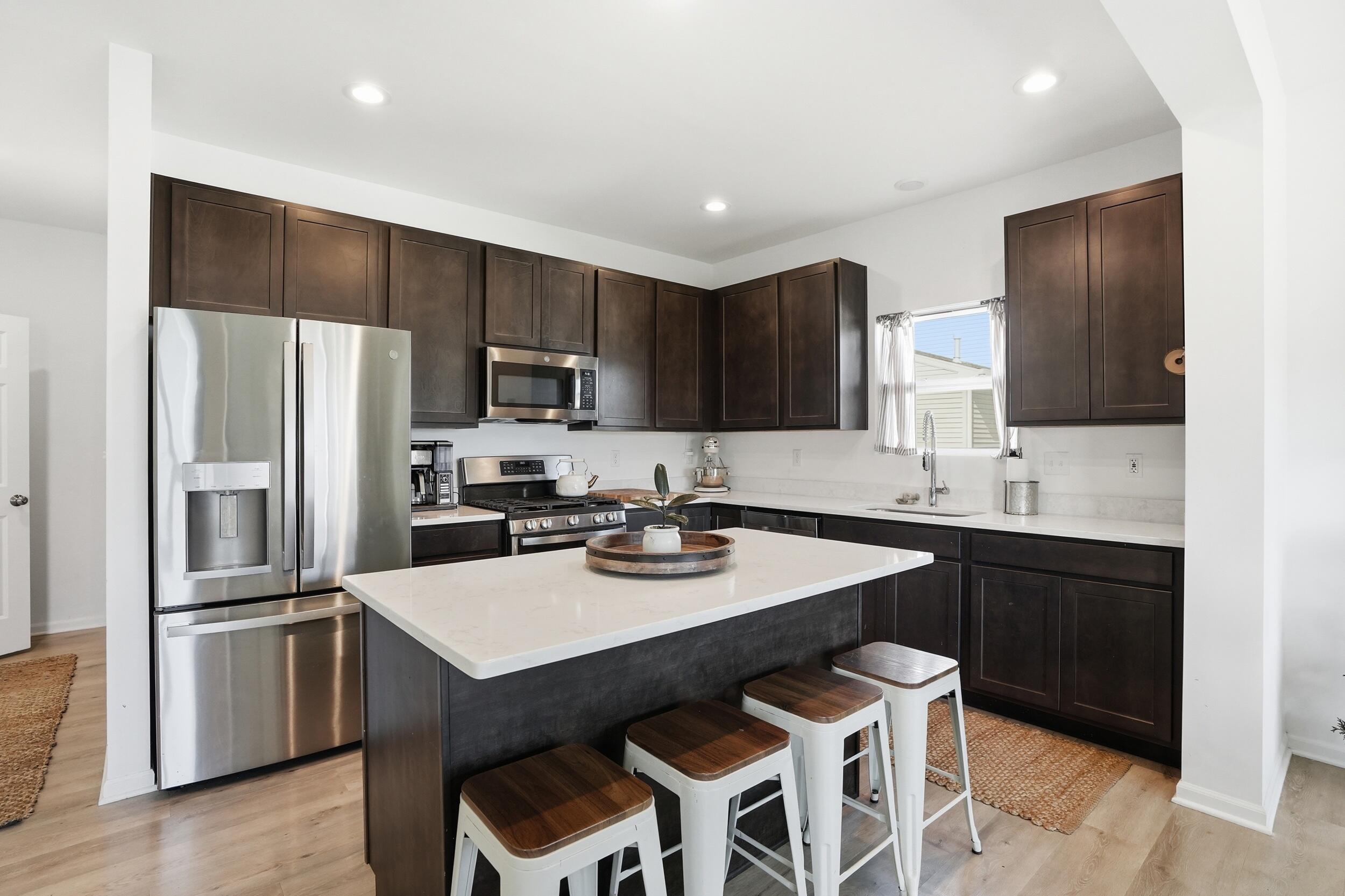 8658 Valley Forge Way Lowell, IN 46356 - Photo 8 of 23 a kitchen with a sink stainless steel appliances and refrigerator