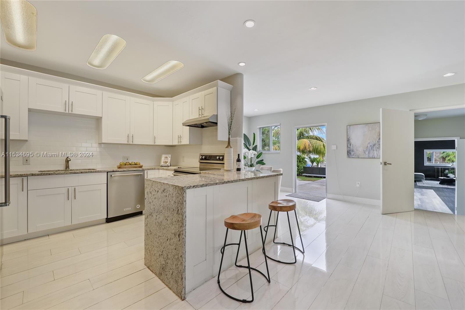 805 Northwest 7th Street Miami, FL 33136 - Photo 11 of 29 a kitchen with white cabinets and stainless steel appliances