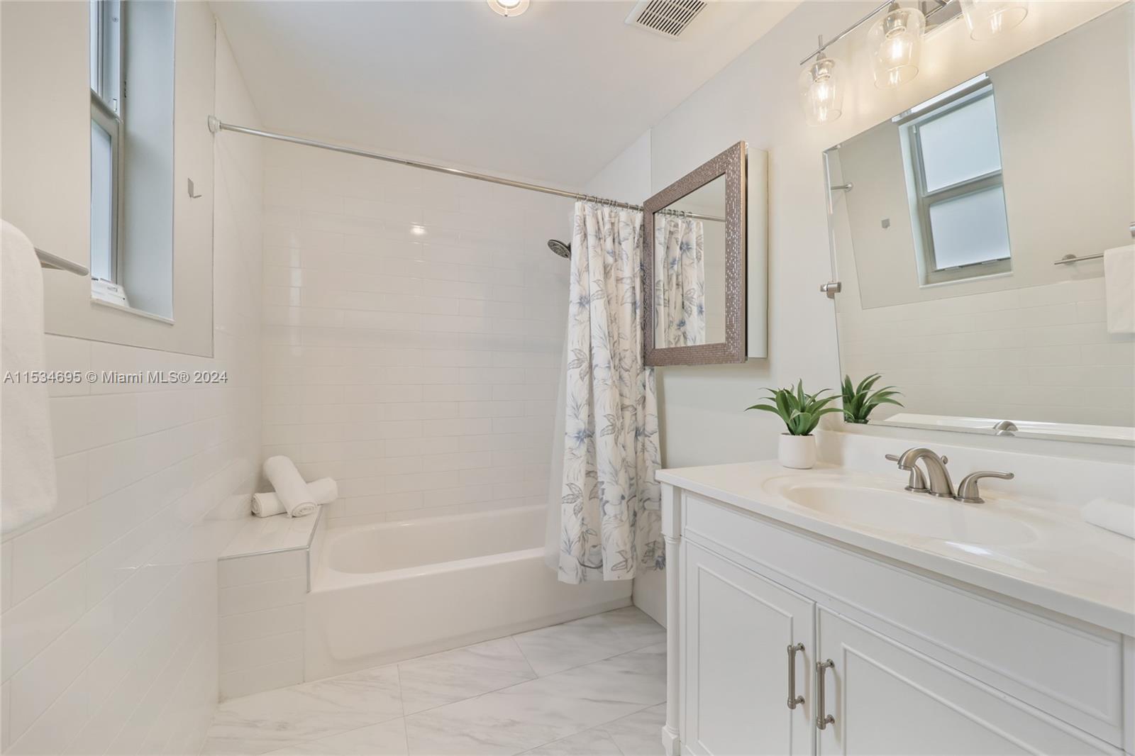 805 Northwest 7th Street Miami, FL 33136 - Photo 16 of 29 a bathroom with a bathtub shower sink and a mirror