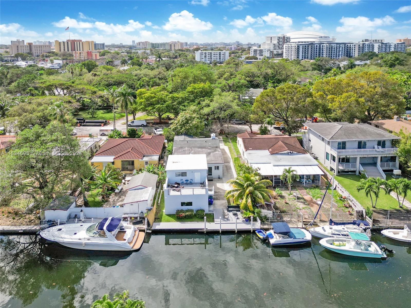 805 Northwest 7th Street Miami, FL 33136 - Photo 4 of 29 a view of a lake with a houses and a mountain view