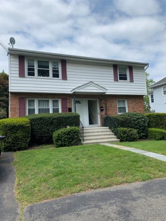 5 Triangle Street, Unit B Norwalk, CT 06855 - Photo 1 of 1 a front view of a house with a yard