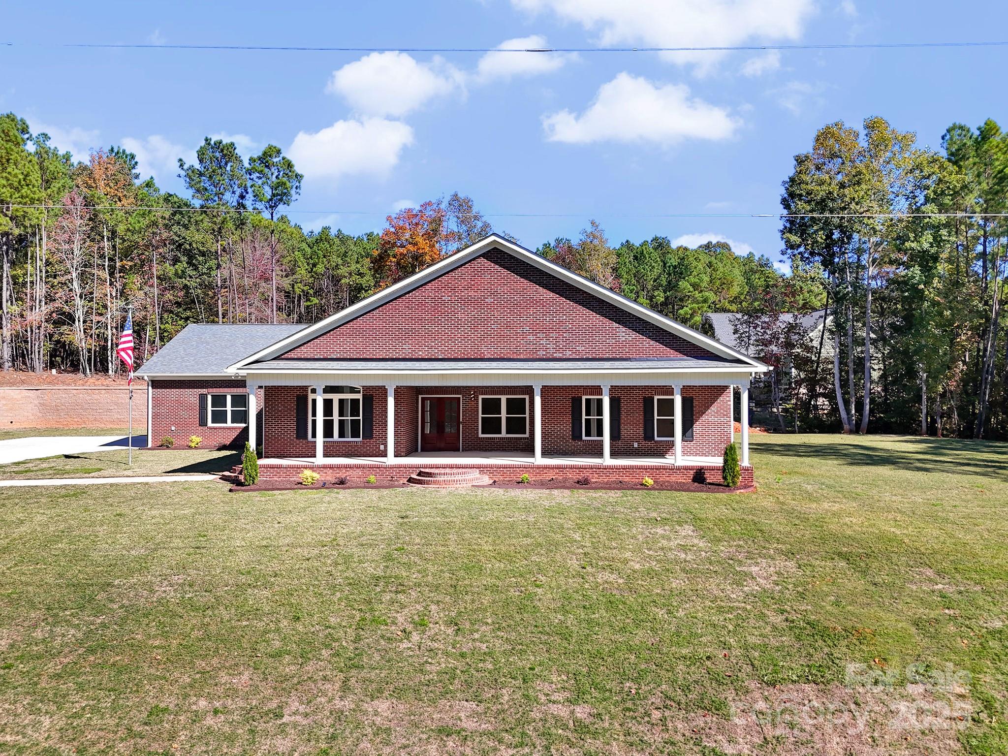 1199 Brunson Road Fort Lawn, SC 29714 - Photo 5 of 48 a view of a house with table and chairs under an umbrella