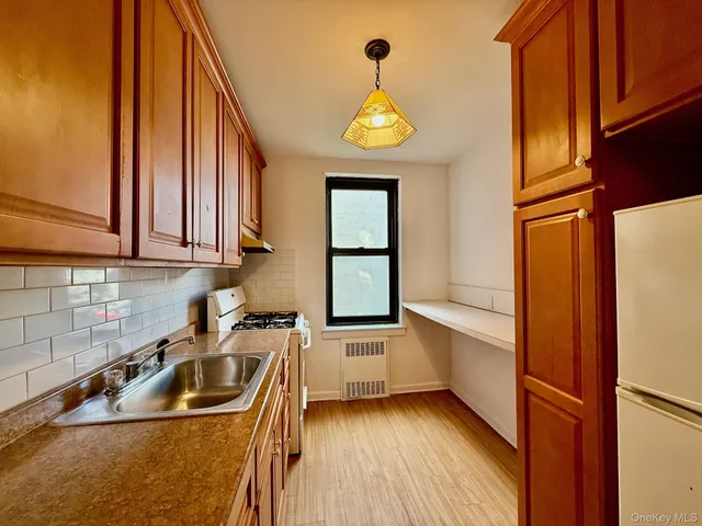 a kitchen with stainless steel appliances a sink a stove and a window
