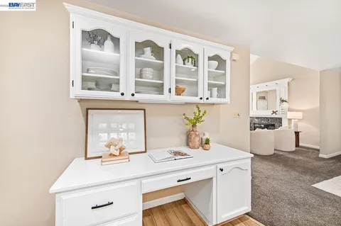 a kitchen with granite countertop white cabinets and white appliances