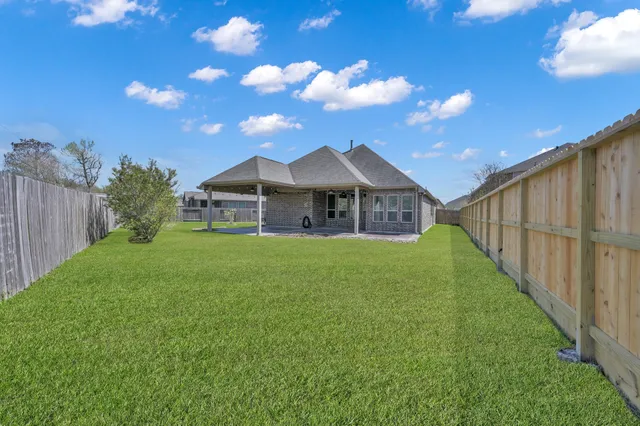 a front view of a house with a garden and yard