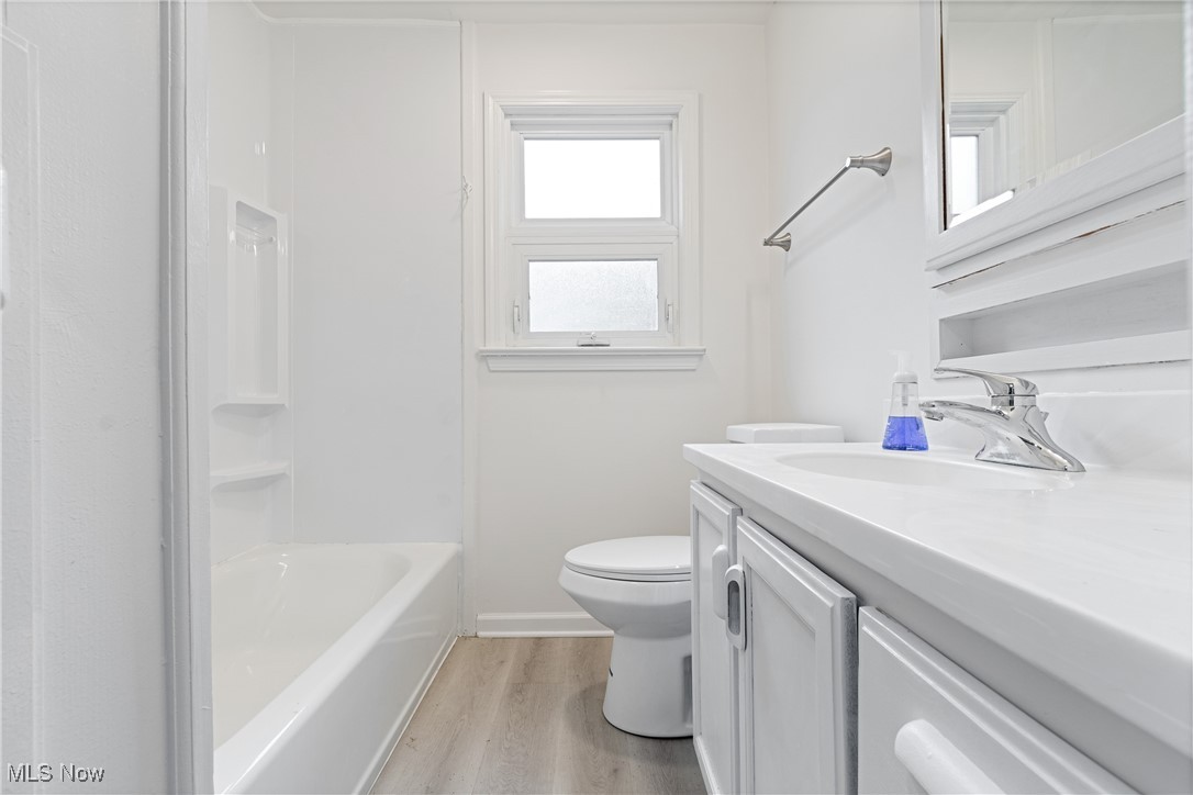 1057 Renfield Road Cleveland Heights, OH 44121 - Photo 20 of 30 Bathroom featuring vanity, toilet, and hardwood / wood-style flooring
