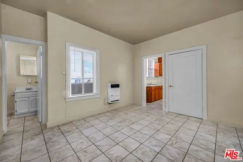 a room with stainless steel appliances granite countertop a stove a sink and dishwasher