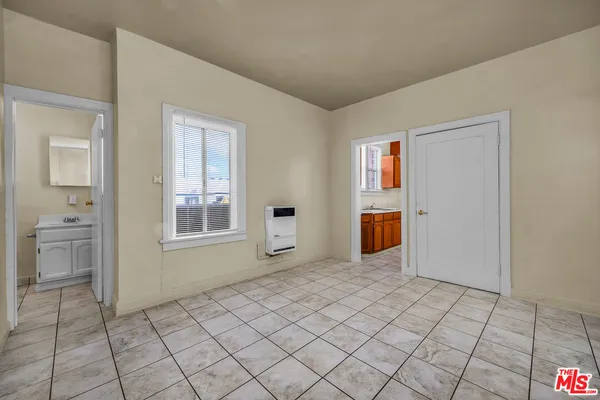 a room with stainless steel appliances granite countertop a stove a sink and dishwasher