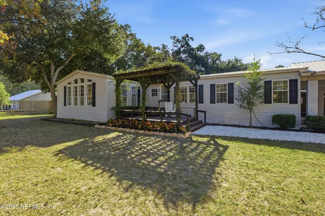 an aerial view of a house with garden space and street view