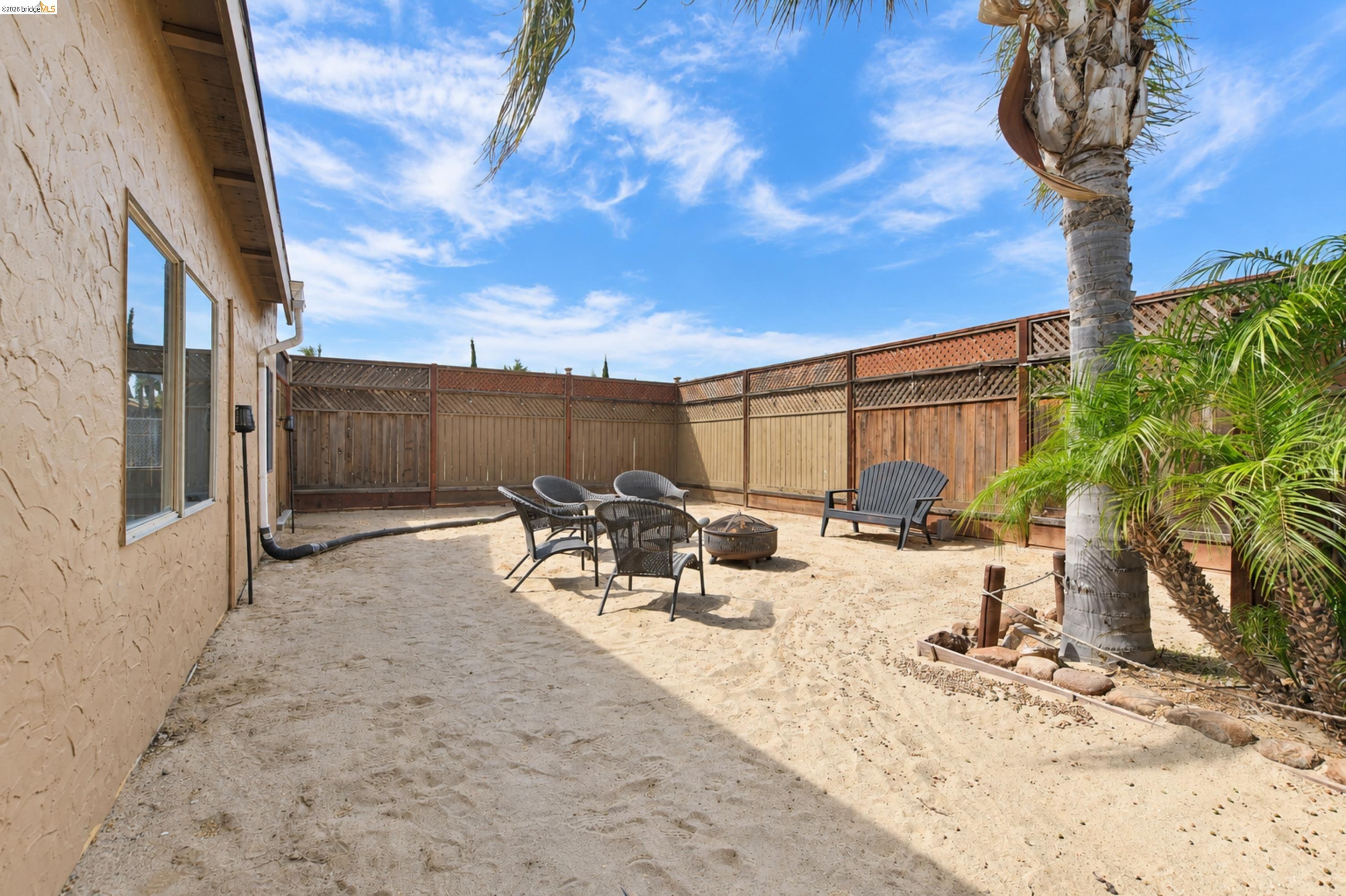 340 West Bolton Road Oakley, CA 94561 - Photo 65 of 87 Backyard with stucco-finished exterior, multiple windows, and a wood privacy fence