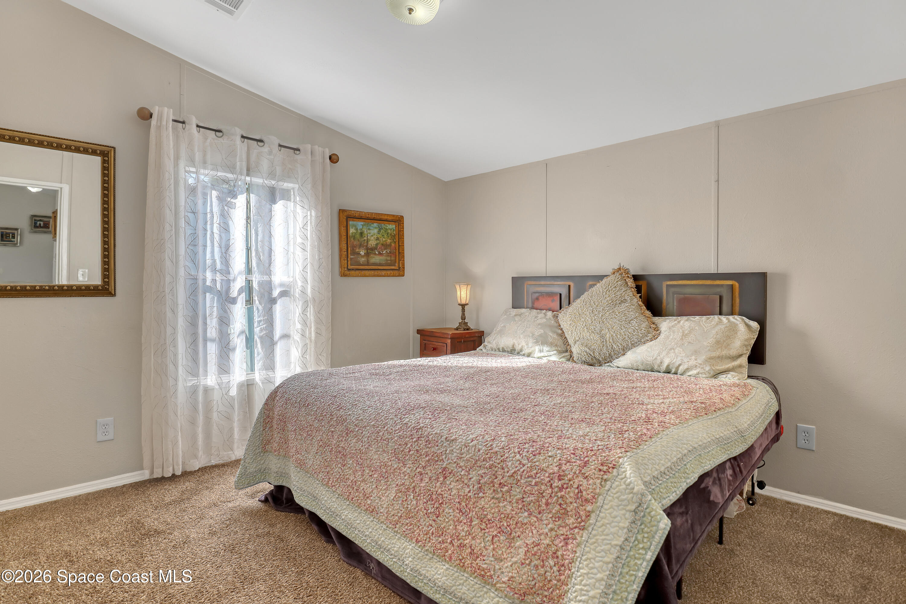 354 Akorn Street Cocoa, FL 32927 - Photo 11 of 29 a bedroom with a bed and window