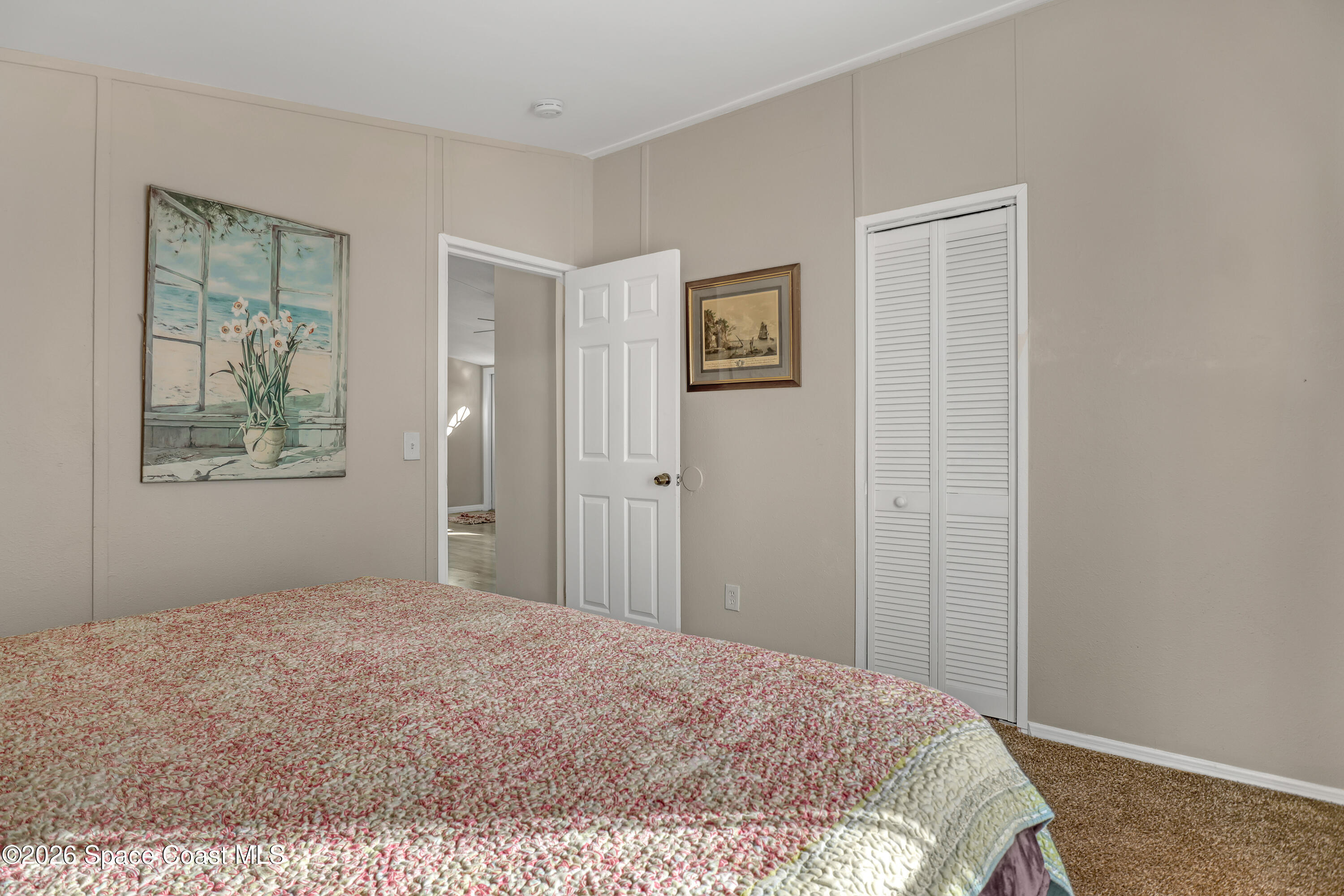 354 Akorn Street Cocoa, FL 32927 - Photo 12 of 29 a bedroom with a bed and a painting on the wall