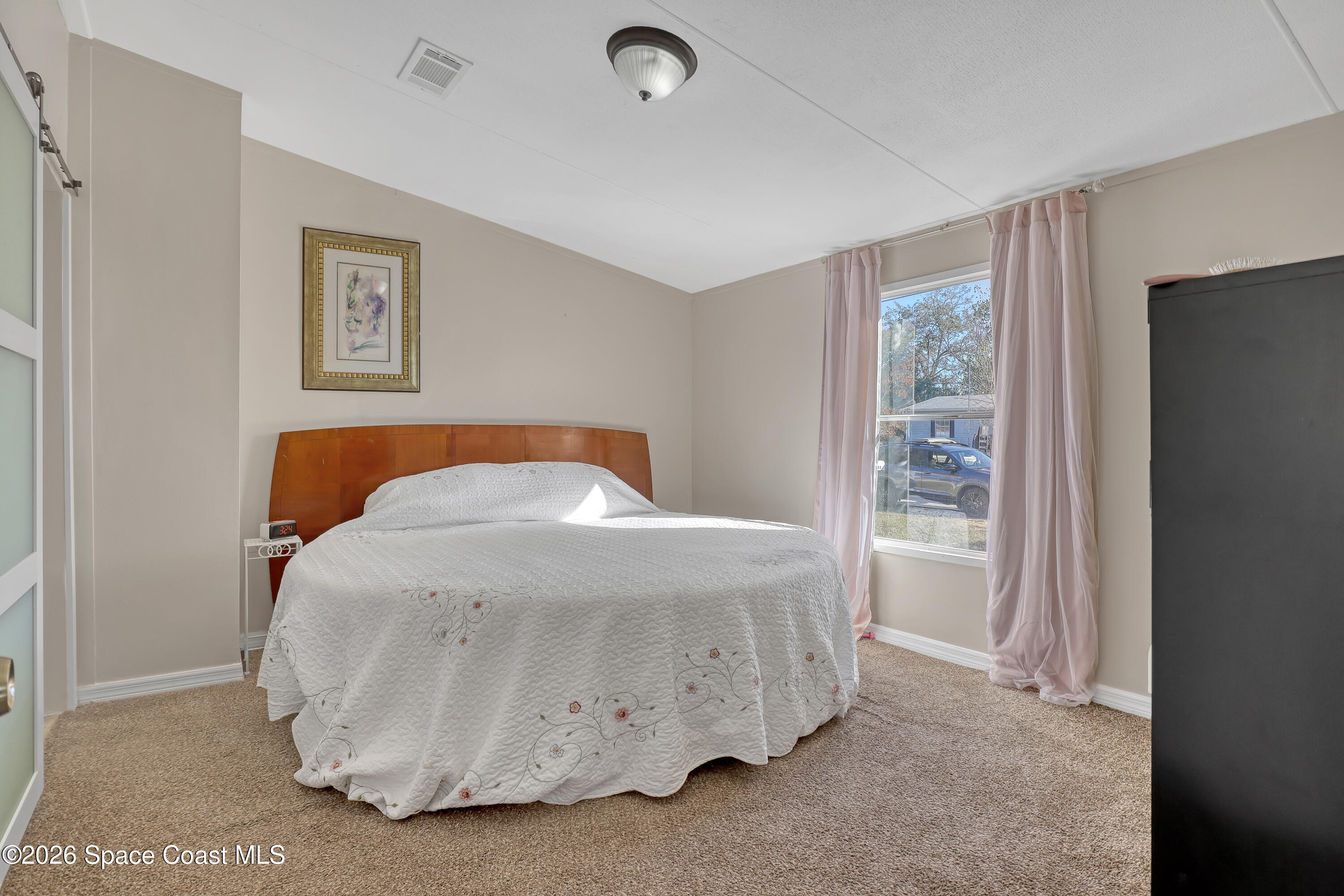 354 Akorn Street Cocoa, FL 32927 - Photo 8 of 29 a bedroom with a bed and a window