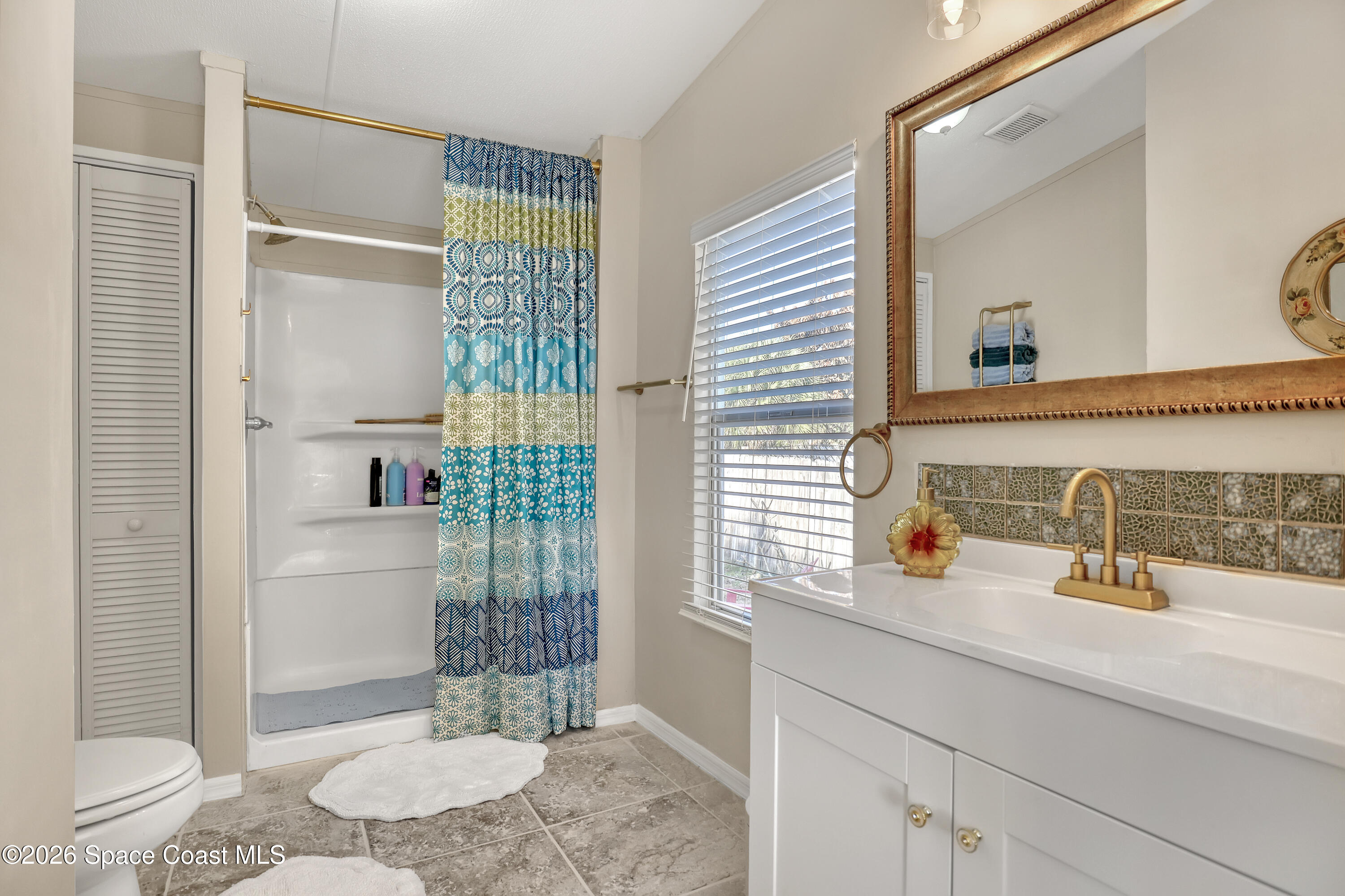 354 Akorn Street Cocoa, FL 32927 - Photo 10 of 29 a bathroom with a sink a toilet and shower