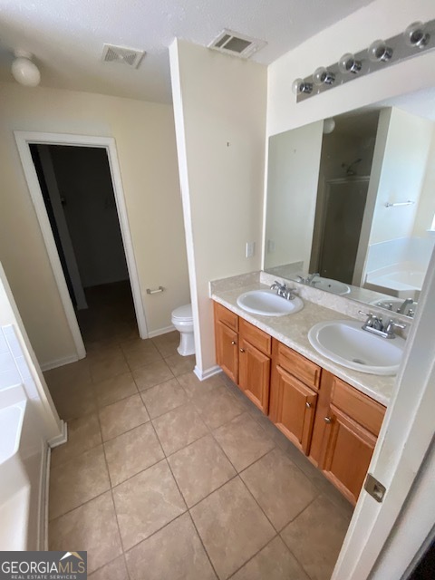 530 Shire Lane Fairburn, GA 30213 - Photo 14 of 36 a bathroom with a sink a toilet and mirror