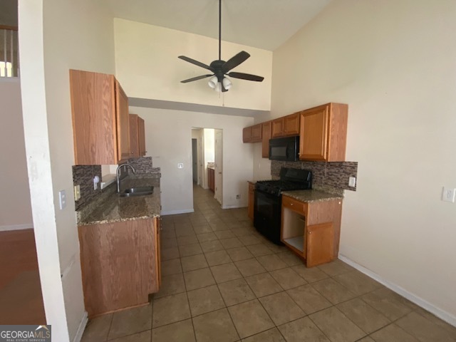 530 Shire Lane Fairburn, GA 30213 - Photo 8 of 36 a kitchen with stainless steel appliances a sink a stove top oven a chimney and a window