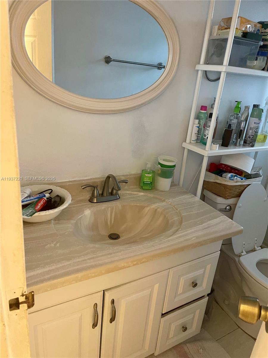 8351 Sands Point Boulevard, Unit A208 Tamarac, FL 33321 - Photo 12 of 15 a bathroom with a sink and a toilet