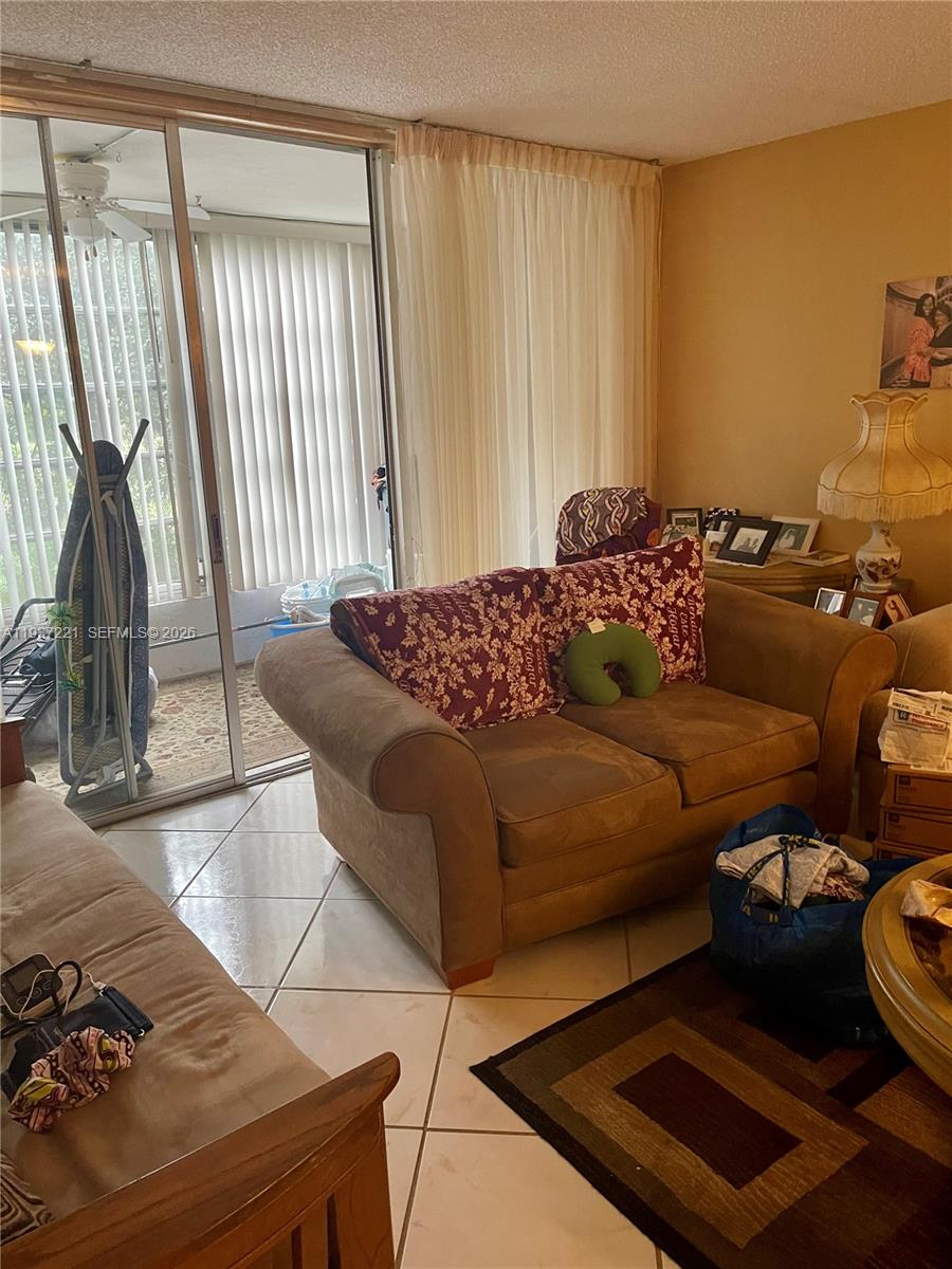 8351 Sands Point Boulevard, Unit A208 Tamarac, FL 33321 - Photo 14 of 15 a bedroom with a bed and a dresser