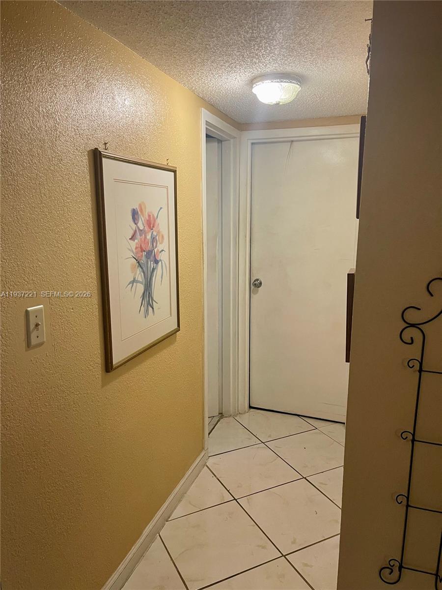 8351 Sands Point Boulevard, Unit A208 Tamarac, FL 33321 - Photo 6 of 15 a view of wall painting and refrigerator