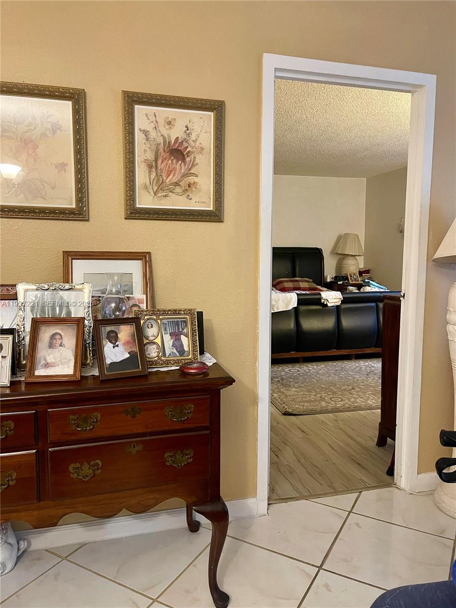 8351 Sands Point Boulevard, Unit A208 Tamarac, FL 33321 - Photo 8 of 15 a living room with hard wood flooring