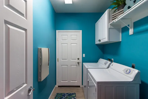 a utility room with a sink washer and dryer
