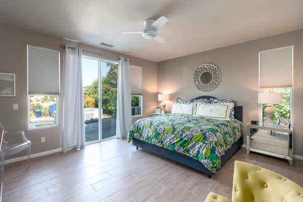 a bedroom with a balcony a bed and window