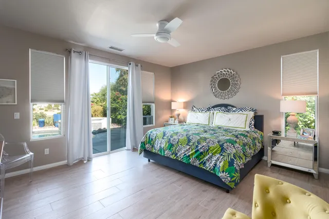 a bedroom with a large bed and a large window