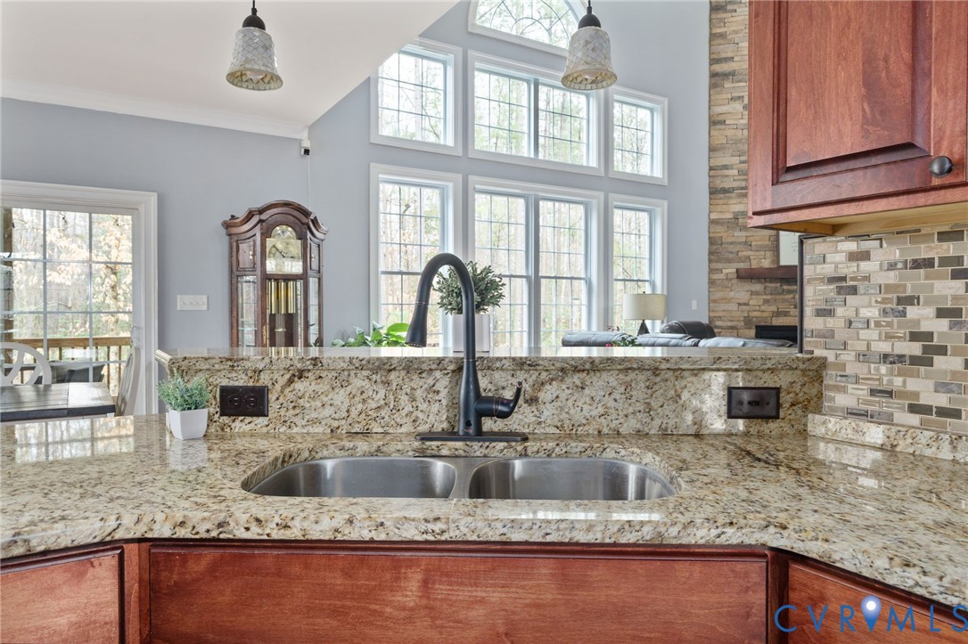 8825 First Branch Lane Chesterfield, VA 23838 - Photo 14 of 63 a kitchen with granite countertop a sink and a large window