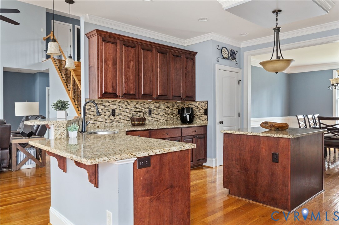 8825 First Branch Lane Chesterfield, VA 23838 - Photo 16 of 63 a kitchen with stainless steel appliances granite countertop a sink stove and wooden floor