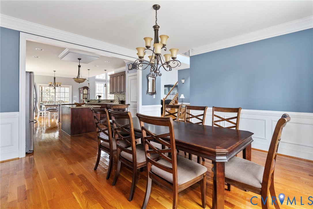 8825 First Branch Lane Chesterfield, VA 23838 - Photo 20 of 63 a view of a dining room with furniture and wooden floor