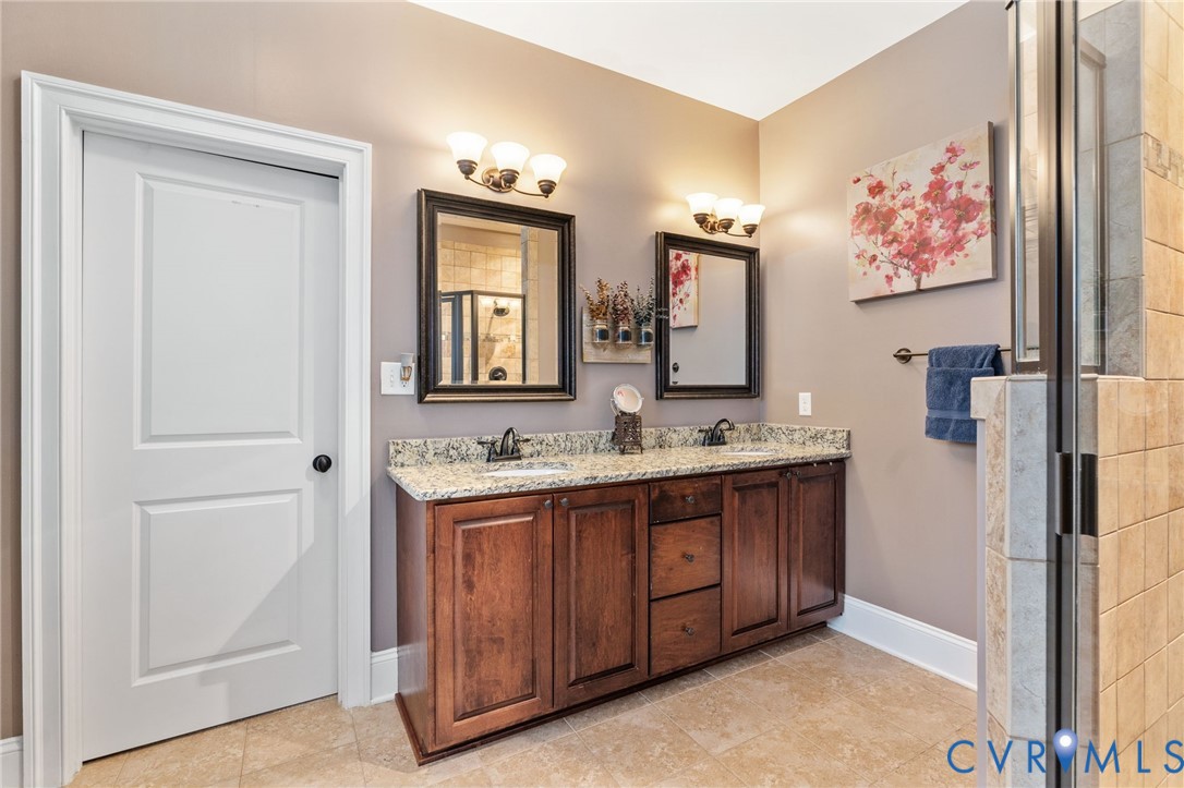 8825 First Branch Lane Chesterfield, VA 23838 - Photo 25 of 63 a spacious bathroom with a double vanity sink and a mirror