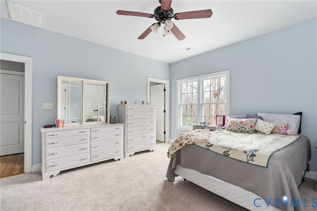 8825 First Branch Lane Chesterfield, VA 23838 - Photo 33 of 63 a bedroom with a bed and a chandelier fan