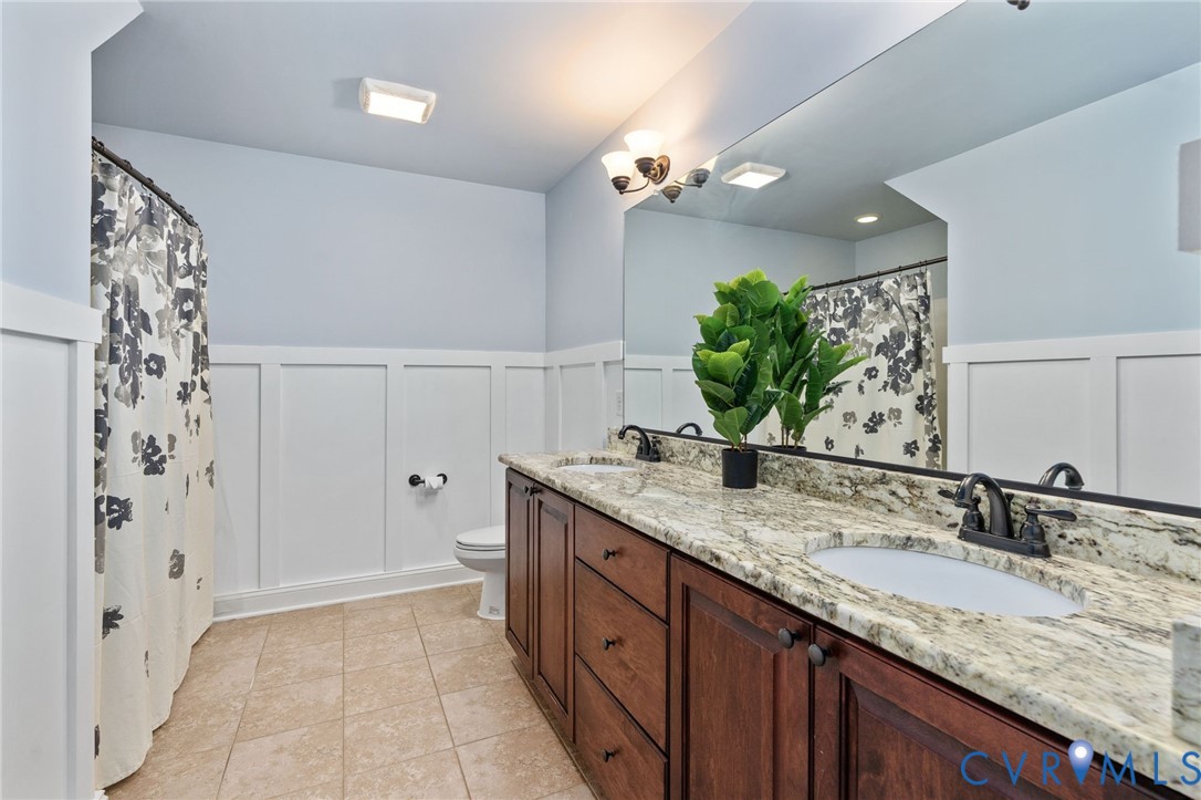 8825 First Branch Lane Chesterfield, VA 23838 - Photo 39 of 63 a bathroom with a granite countertop double vanity sink mirror and shower