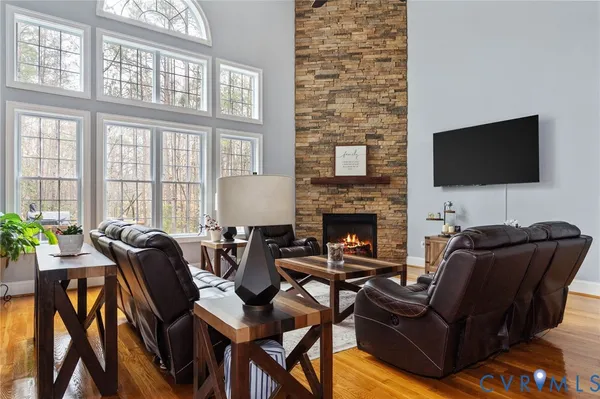 a living room with furniture fireplace and a window