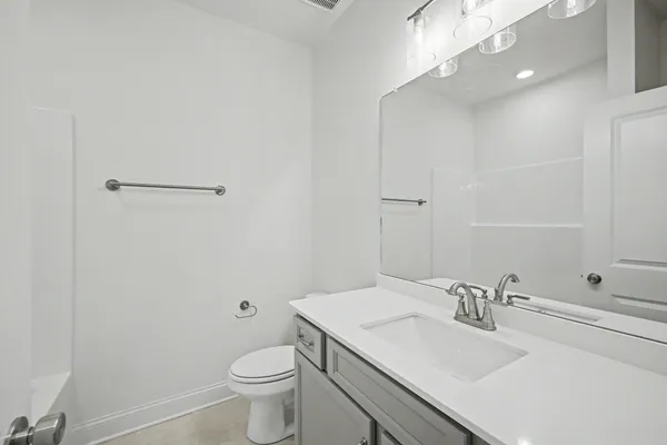 a view of an empty room with a fireplace and window