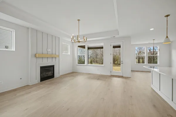 a view of a livingroom with a fireplace stairs and a window