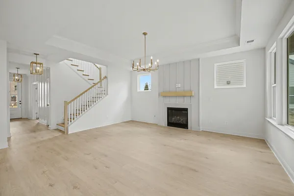a view of a kitchen with kitchen island a sink stainless steel appliances and cabinets