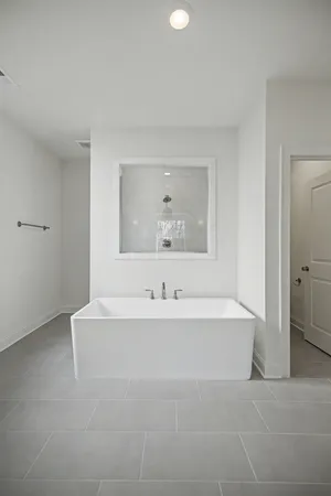 a bathroom with a bathtub sink and mirror