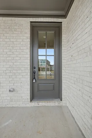 a view of a hallway with wooden floor and entryway