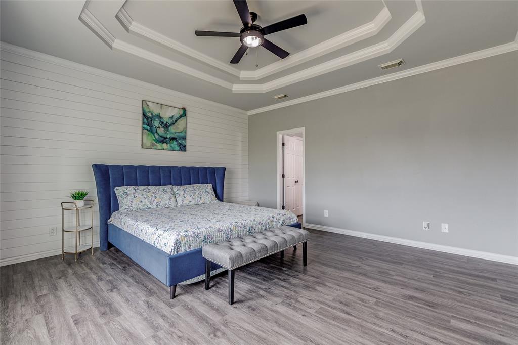 11744 Foutch Road Pilot Point, TX 76258 - Photo 18 of 35 a bedroom with a bed and a ceiling fan