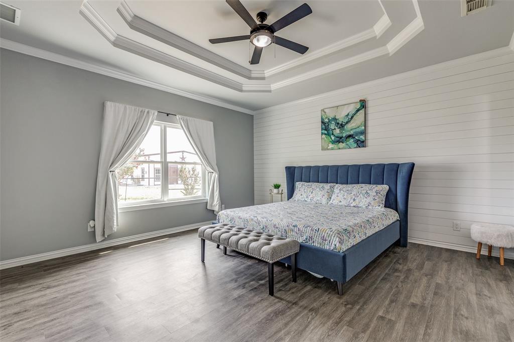 11744 Foutch Road Pilot Point, TX 76258 - Photo 19 of 35 a spacious bedroom with a bed and a window