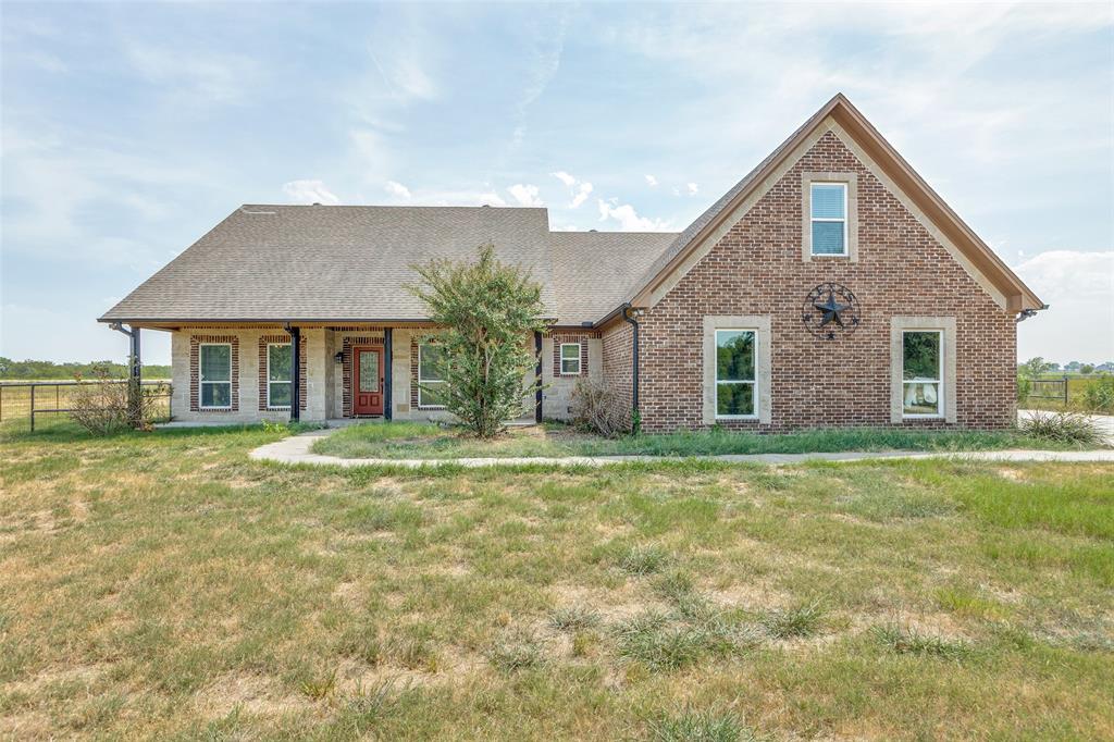 11744 Foutch Road Pilot Point, TX 76258 - Photo 2 of 35 a front view of a house with a garden
