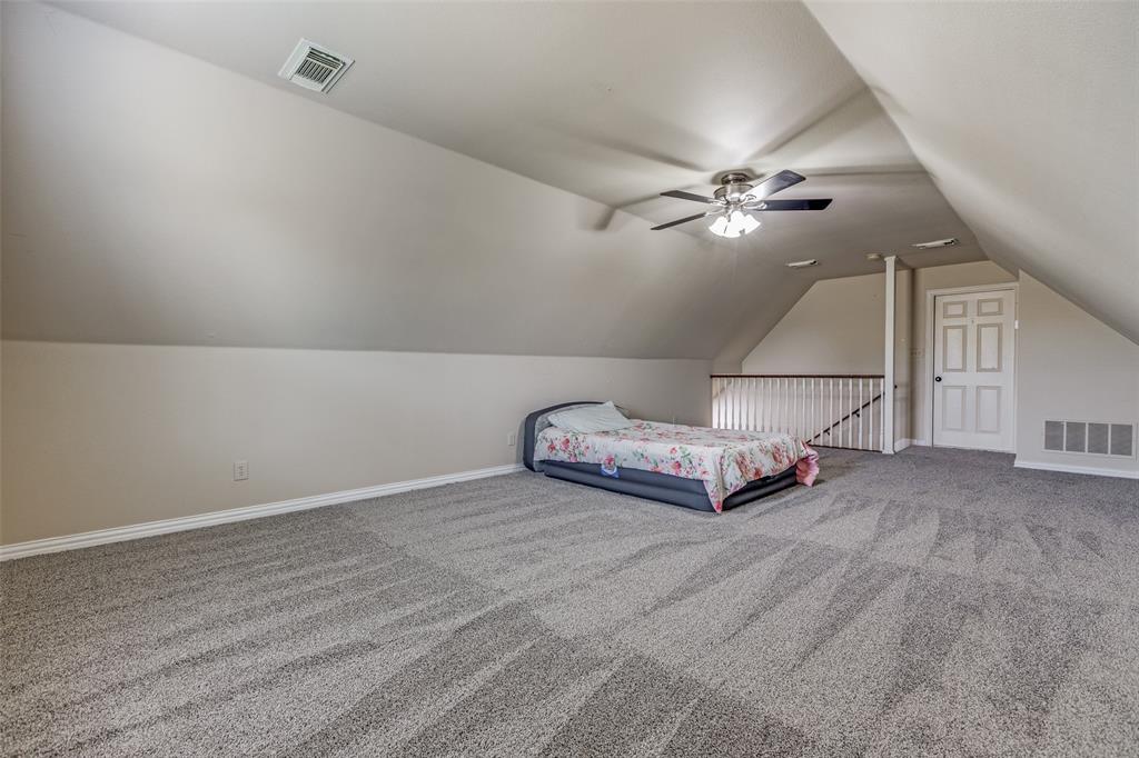 11744 Foutch Road Pilot Point, TX 76258 - Photo 22 of 35 an empty room with chandelier fan and windows