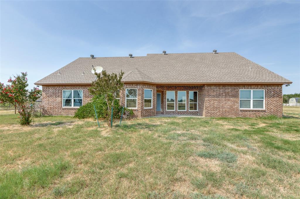 11744 Foutch Road Pilot Point, TX 76258 - Photo 27 of 35 a front view of a house with a garden