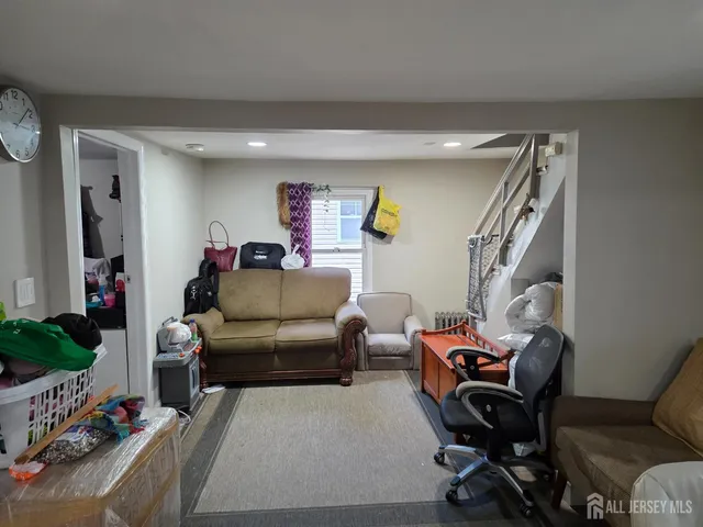 a living room with furniture and a piano