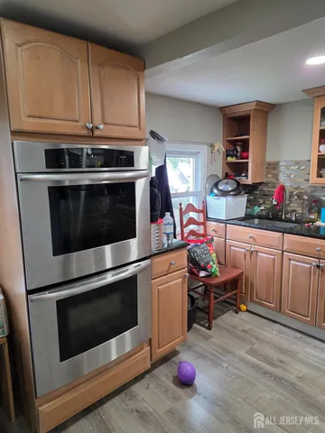 a kitchen with a stove and white cabinets
