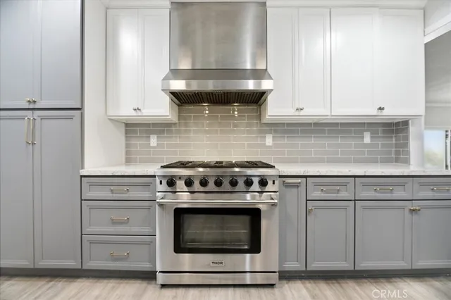 a kitchen with a sink cabinets and stainless steel appliances